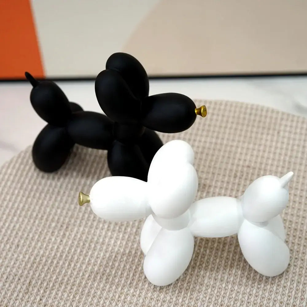 Modern black and gold crackle balloon dog sculpture with gold-tipped noses for living room decor in black and white