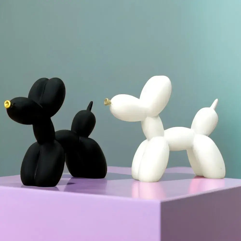 Modern black and white balloon dog sculpture with gold-tipped noses for contemporary living room decor