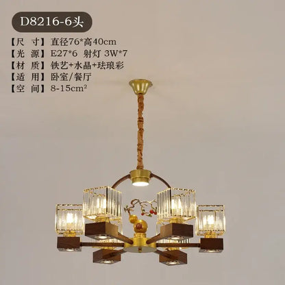 Modern black and gold crystal dining room chandelier with six crystal lights, wooden bases, and vine design decorbites crystal dining
