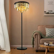 Modern black and gold crystal floor lamp with cascading tiers of golden glass elements for living room decor