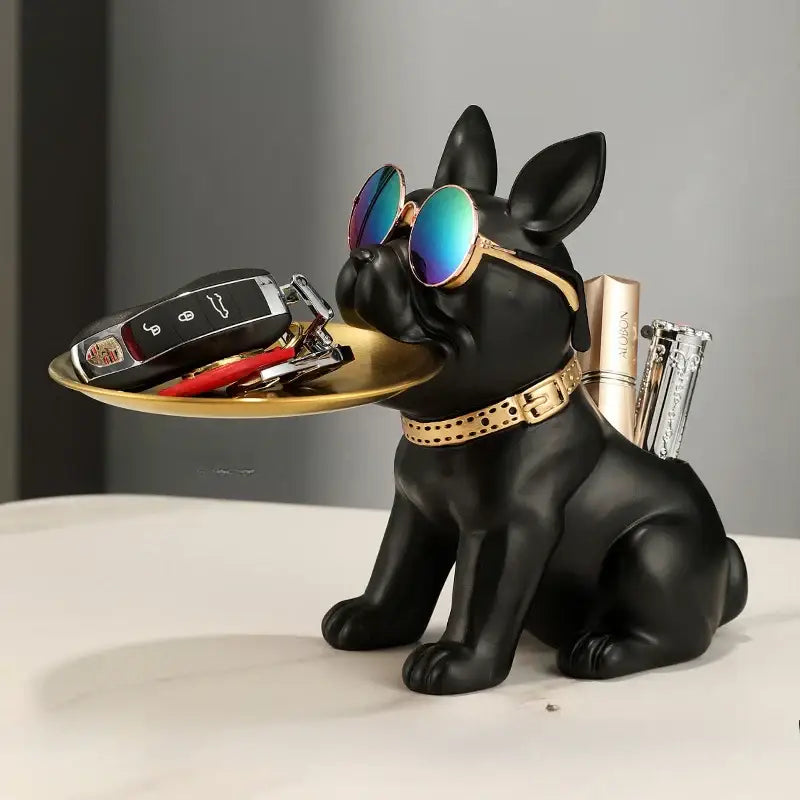 Modern black and gold decorbites bulldog statue featuring a black french bulldog with gold-trimmed sunglasses holding a tray