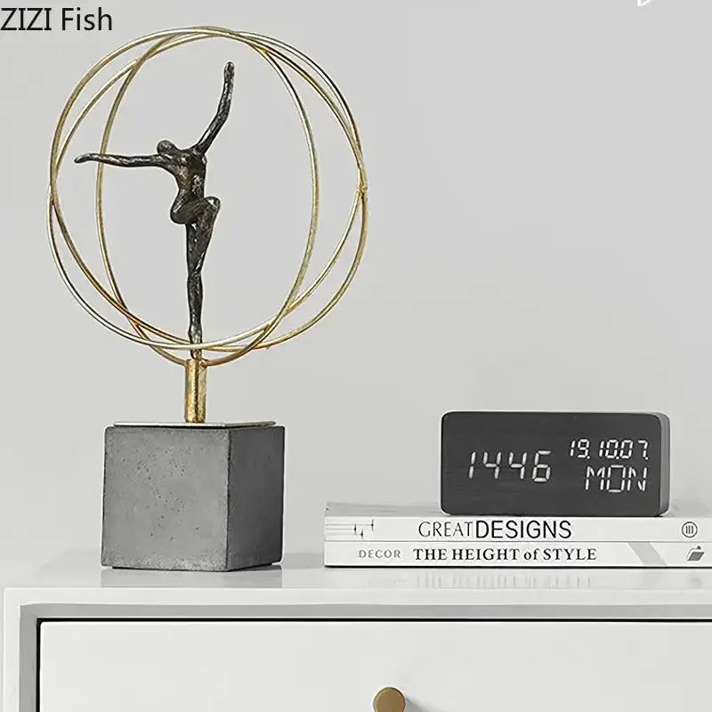 Bronze gymnast figures statue encased in circular gold wire frame on gray concrete base modern decorbites gymnast figures