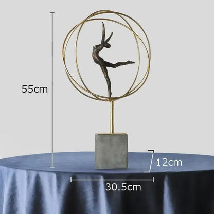 Bronze-colored decorbites gymnast figures statue encased in gold rings on concrete base modern living room sculpture