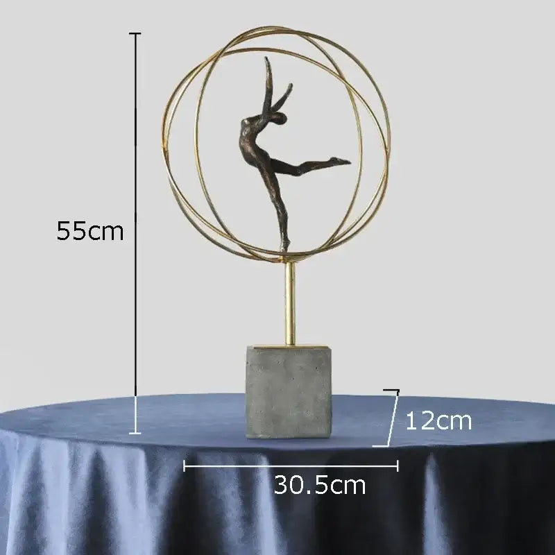 Bronze-colored decorbites gymnast figures statue encased in gold rings on concrete base modern living room sculpture