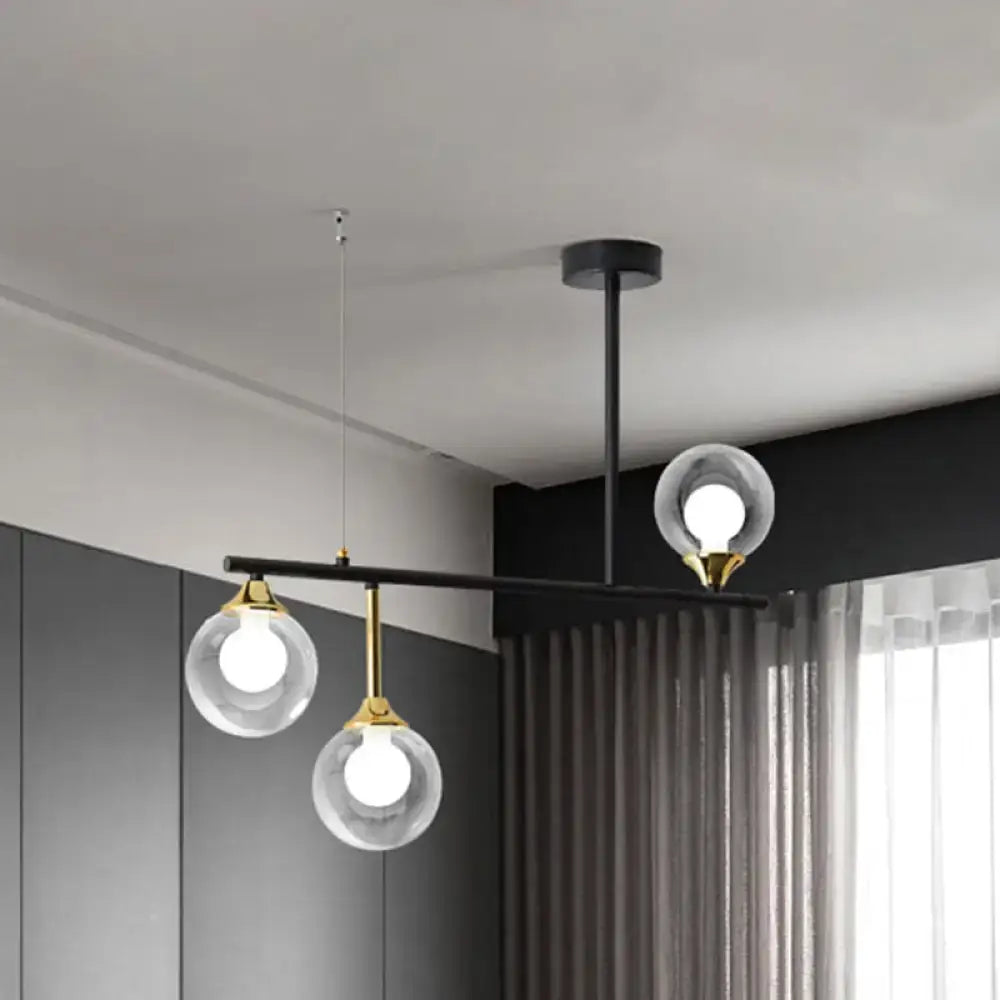 DecorBites™ modern black metal island chandelier with three clear glass ball shades and gold accents for dining room