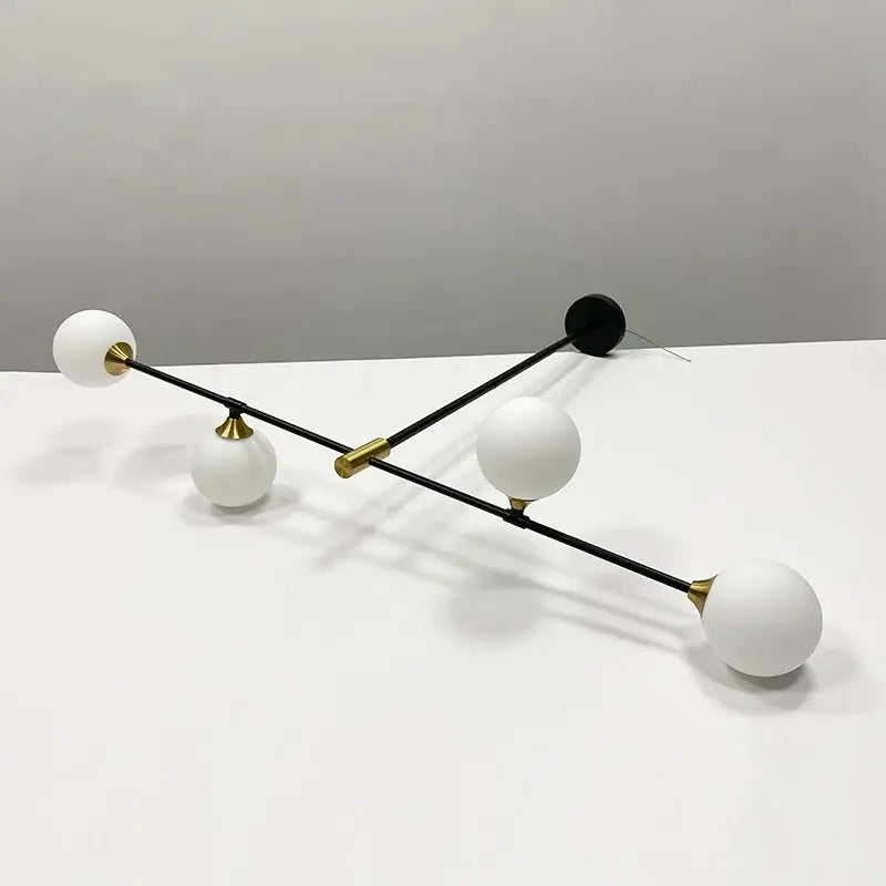 Modern black and brass decorbites glass ball pendant chandelier with four frosted white shades for dining room decor