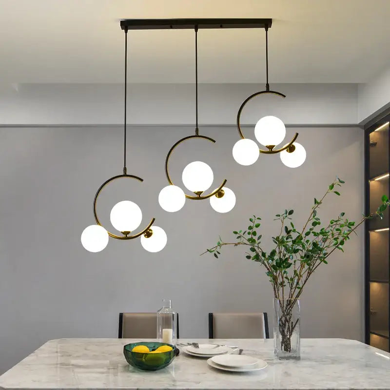 Modern black and gold glass ball pendant light with brass-toned metal arms featuring decorbites glass ball globes for living room decor