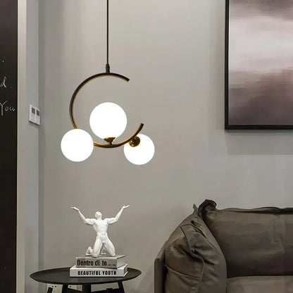 Modern black and gold brass-toned pendant light with three frosted glass ball globes for living room decorbites glass ball pendant