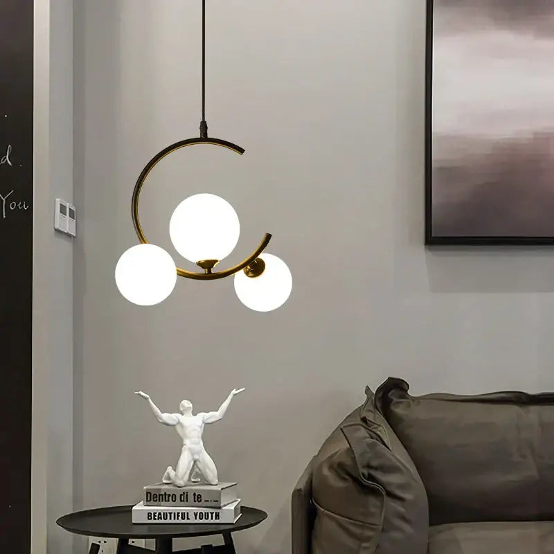 Modern black and gold brass-toned pendant light with three frosted glass ball globes for living room decorbites glass ball pendant