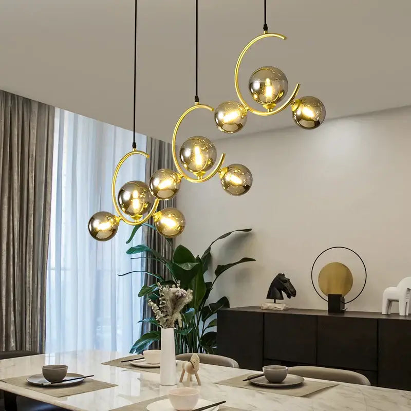 Modern black and gold glass ball pendant light with interconnected rings and reflective orbs for living room decorbites
