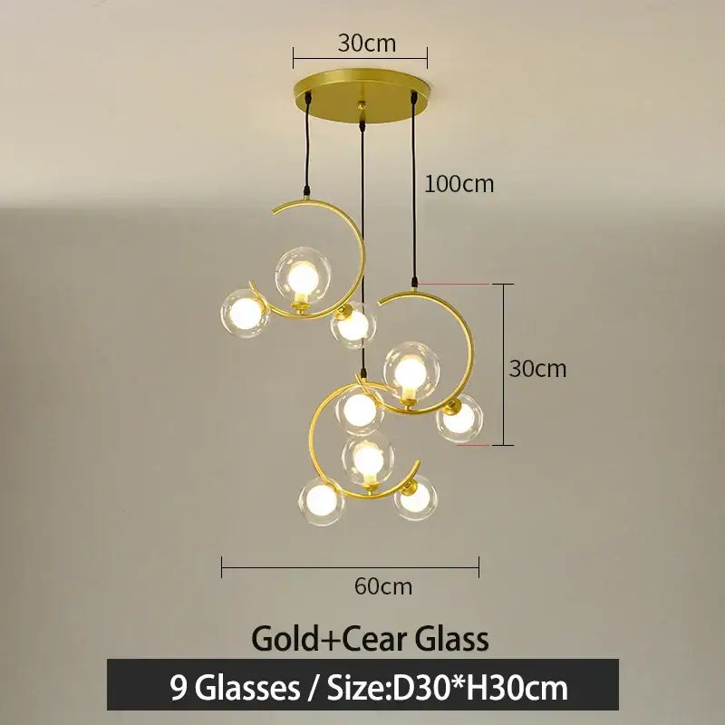 Gold-toned modern pendant light with nine clear glass ball bulbs in an elegant swirling design for living room decorbites glass ball pendant