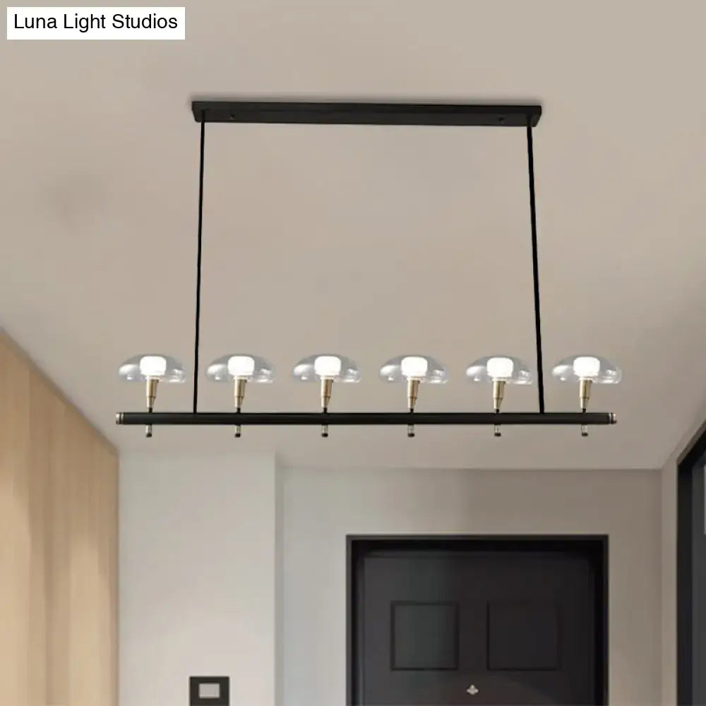 Modern black metal pendant light with five clear glass shades and brass accents ideal for restaurants by decorbites