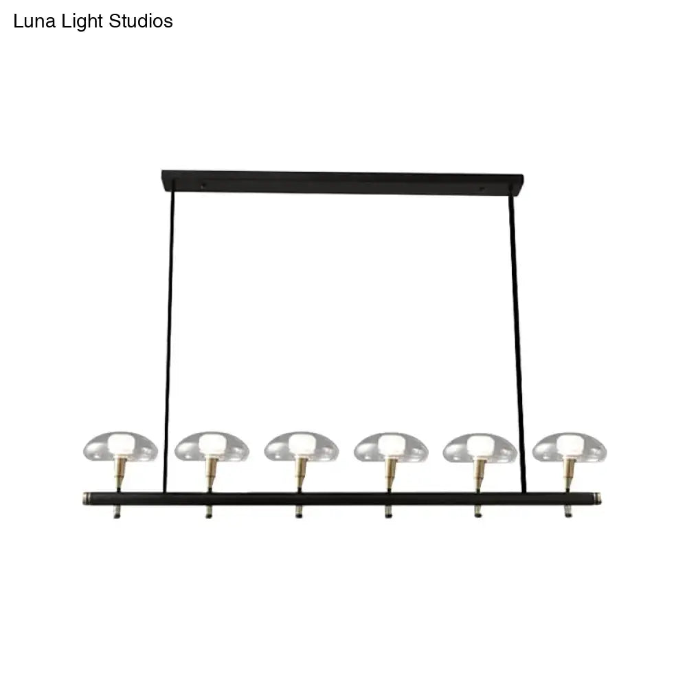 DecorBites black glass island pendant light with five clear glass shades and brass accents ideal for restaurants