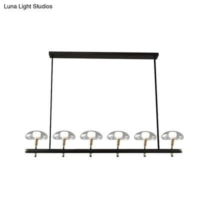 DecorBites black glass island pendant light with five clear glass shades and brass accents ideal for restaurants