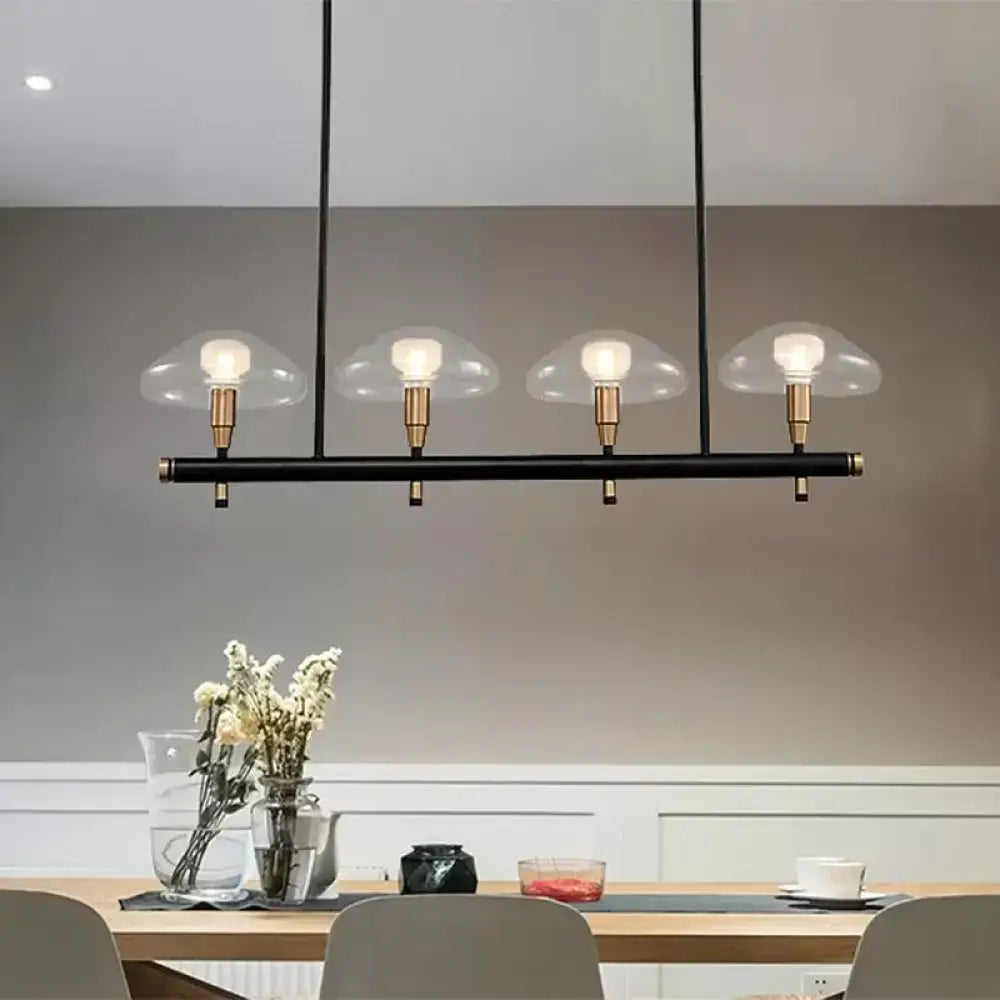 Decorbites black glass island pendant light with brass accents and four clear mushroom glass shades ideal for restaurants