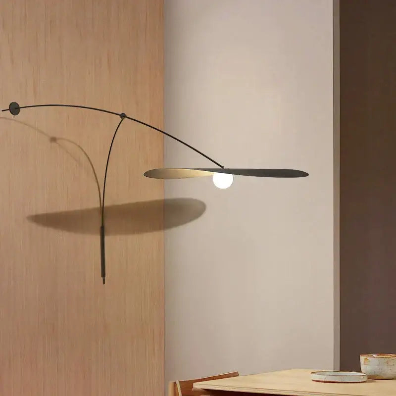 Modern black metal led wall lamp with sleek curved arm and glass shade for elegant bedroom lighting
