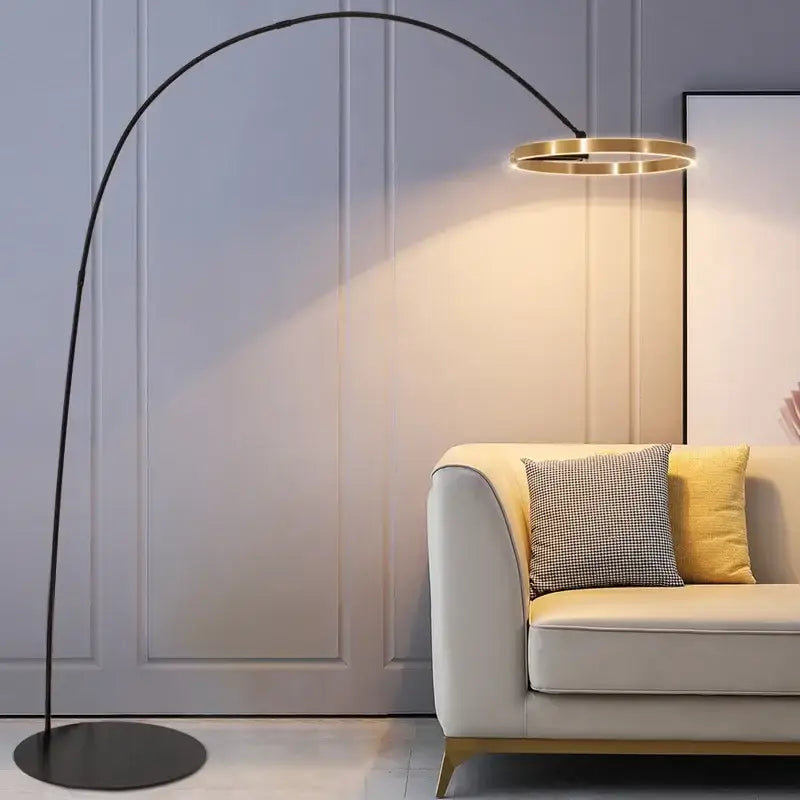 Modern black and gold led floor lamp with metal arc design and circular gold-toned light fixture for living room