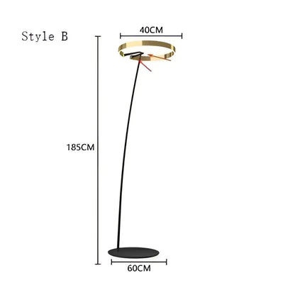 Modern black and gold led floor lamp with gold-toned circular head and sleek curved stem for living room use