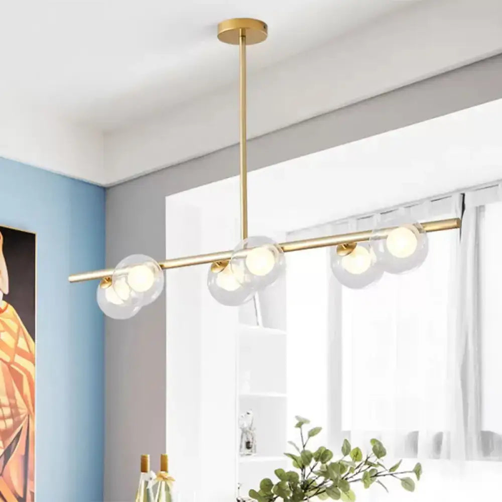 Modern gold-toned DecorBites™ chandelier with clear glass ball light bulbs for dining table island lighting
