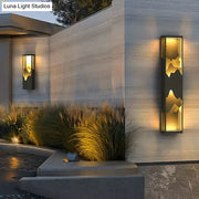 Modern rectangular solar led outdoor light with black frame and illuminated golden mountain silhouette design