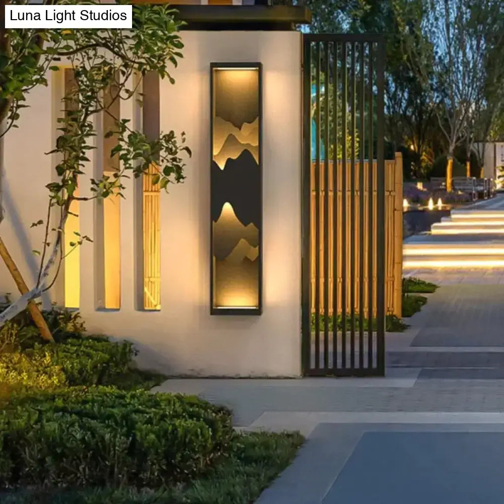 Modern black and gold mountain solar led outdoor light garden sconce with illuminated silhouette design in black frame