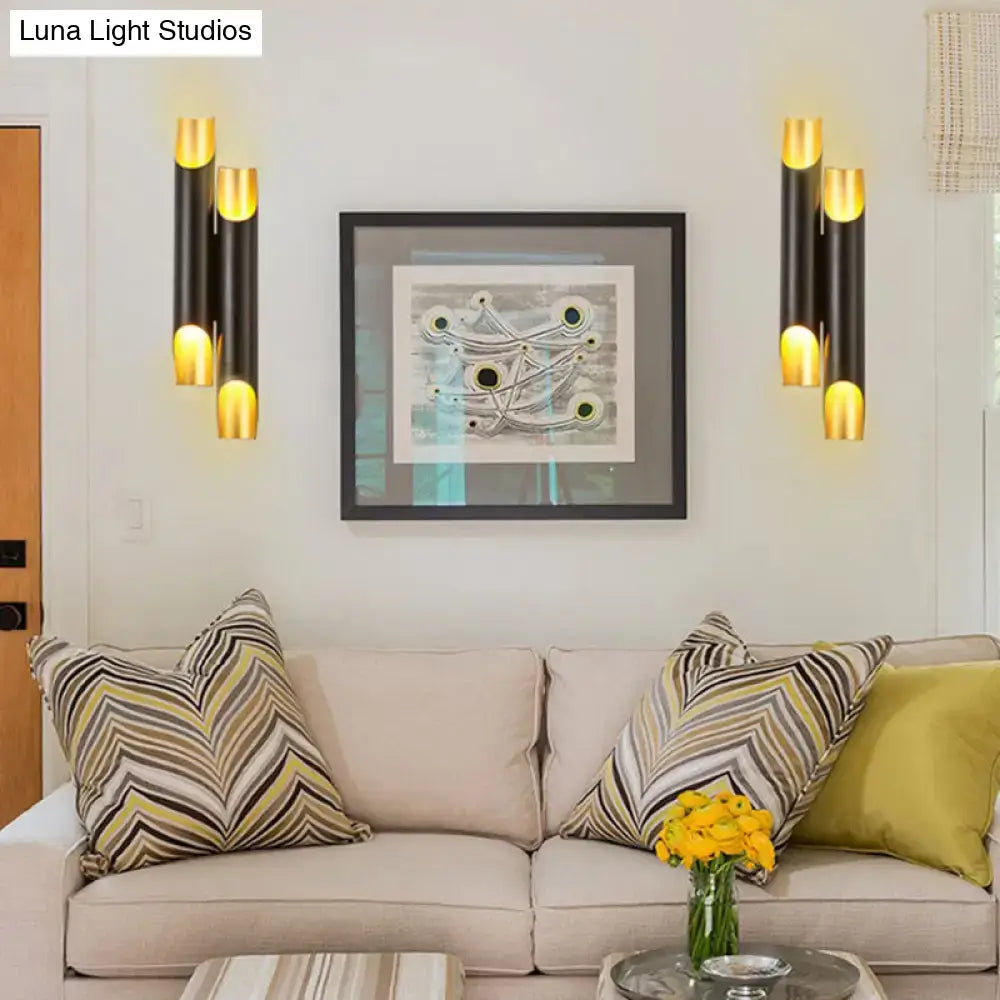 Modern black and gold tubular aluminum wall sconce with cylindrical design for living room lighting