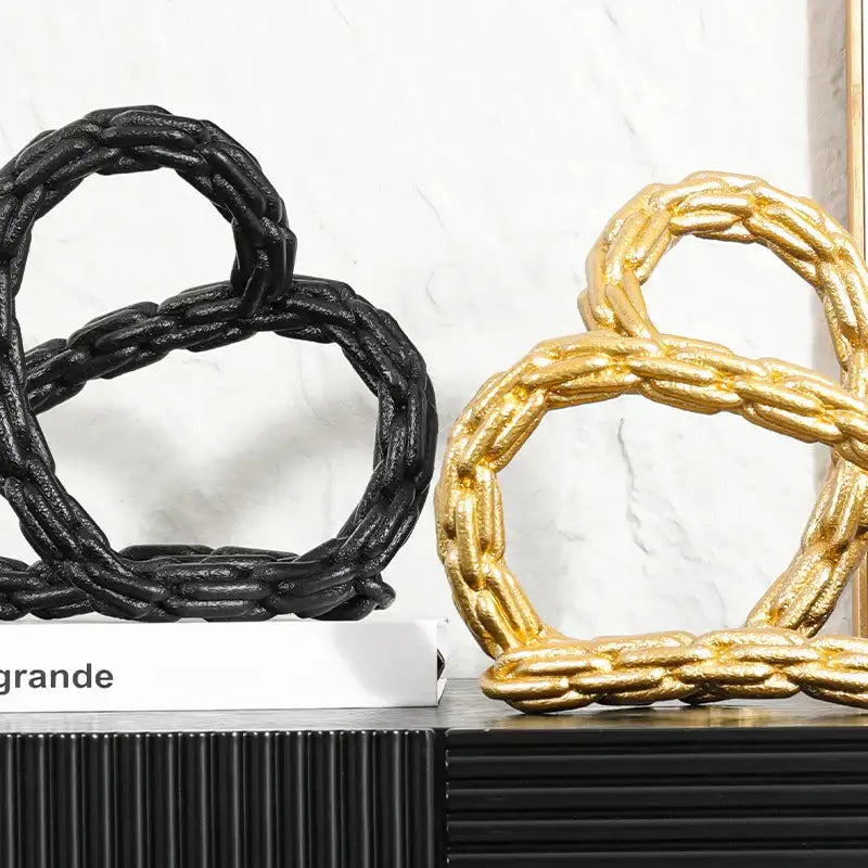 Modern black and golden knot chain sculpture featuring black and gold braided rope-style decorative knot chain rings for living room decor
