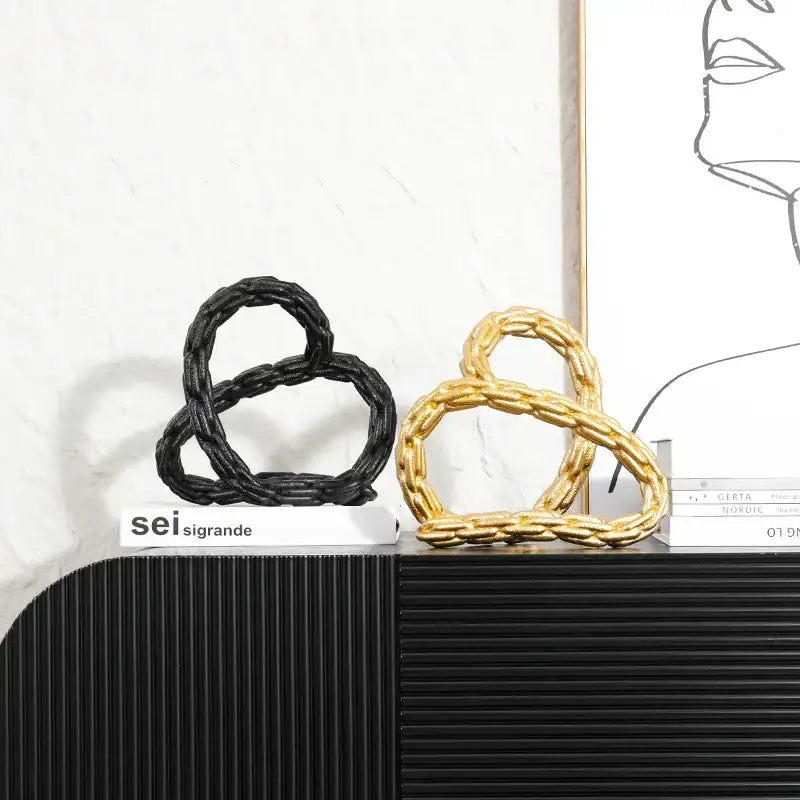 Modern black and golden knot chain sculpture decor featuring twisted golden knot chain design for living room display