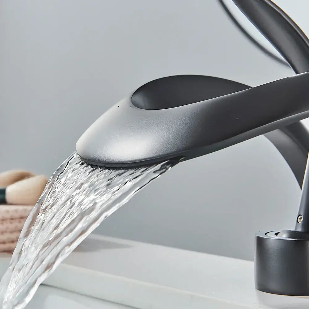 Modern matte black and grey waterfall mixer tap with sleek curved design for bathroom basin faucet use