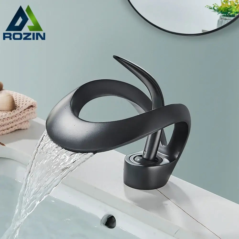 Modern black and grey waterfall mixer tap with matte finish and sleek sculptural design for bathroom basin faucet