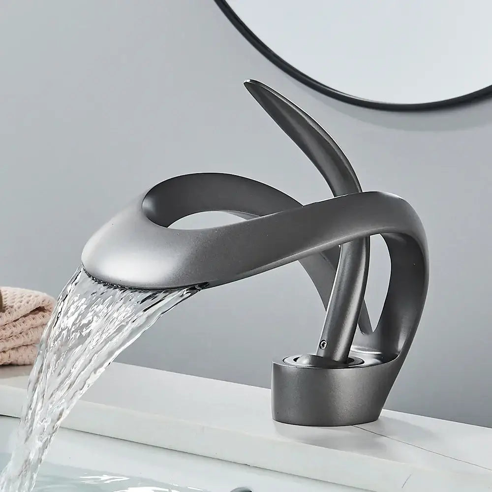 Modern matte black and grey waterfall mixer tap with sleek sculptural design for bathroom basin faucet use