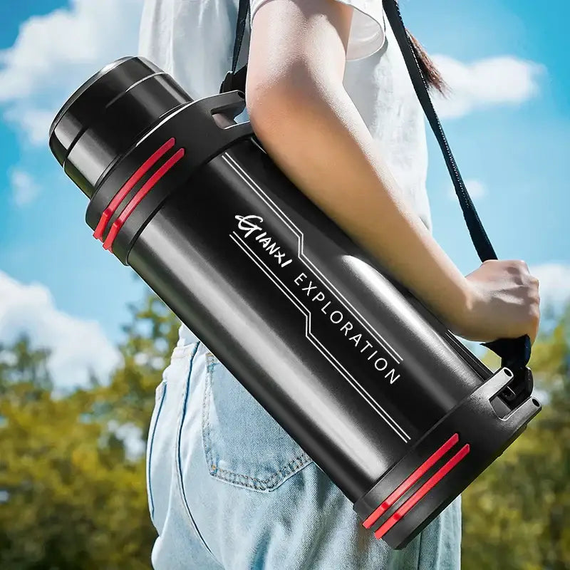Modern black and red stainless steel thermos bottle with giant exploration branding and carrying strap for travel kettle use