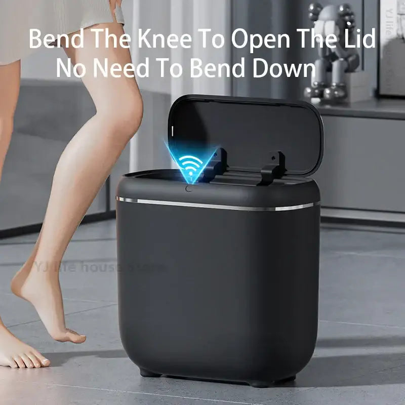 Modern black and silver automatic sensor trash can with sleek trim and knee-activated lid for smart home kitchens