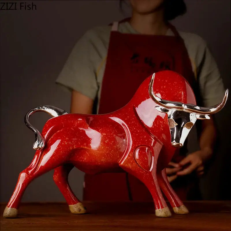 Modern black and silver decorbites bull sculpture with vibrant red ceramic body and polished silver horns and hooves