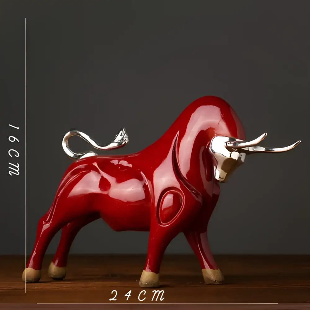 Modern black and silver decorbites bull sculpture featuring a glossy red ceramic bull with silver horns on wooden feet