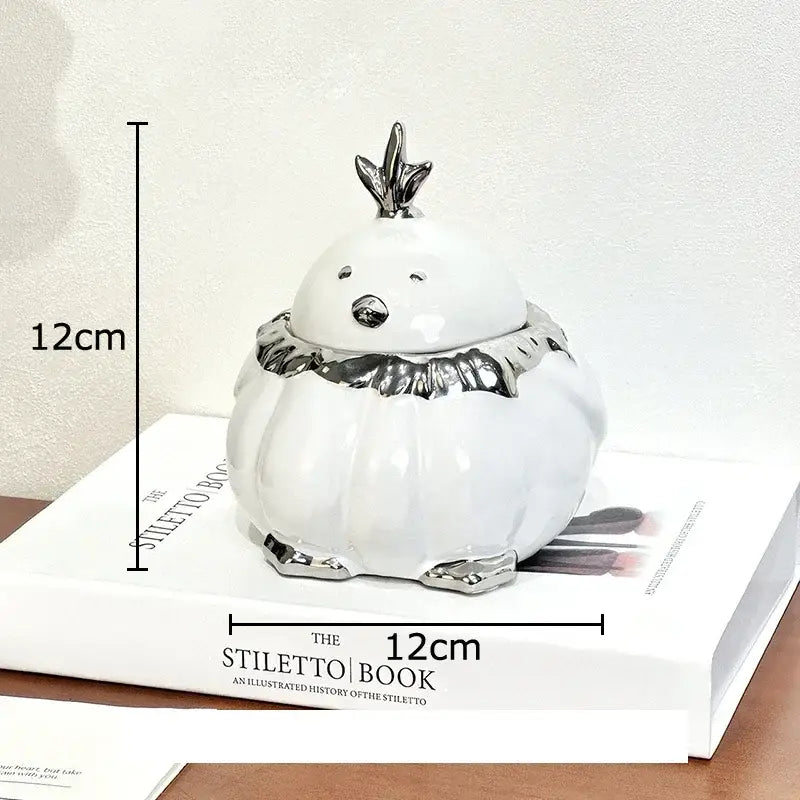 Modern black and silver decorbites duck shaped ceramic ashtray with white ceramic bird jar and silver metallic accents