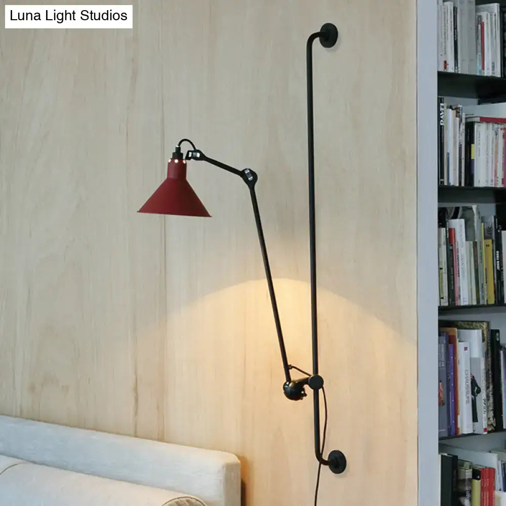 A modern black and white articulated bedroom wall lamp with a red conical shade direct wired electric fixture