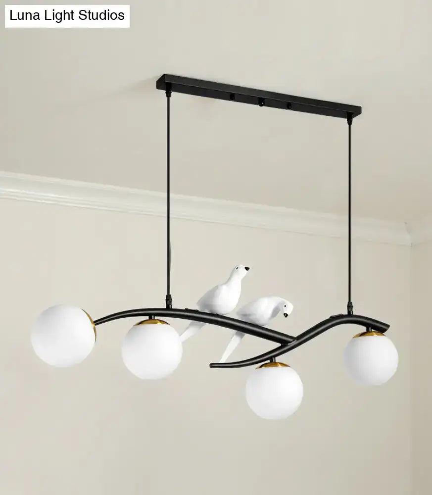 Modern black and white bird linear island pendant light with three white glass shades and sculpted dove figures