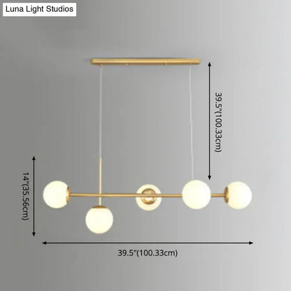 Modern black and white bird linear island pendant light with gold-toned frame and four frosted glass shade globes