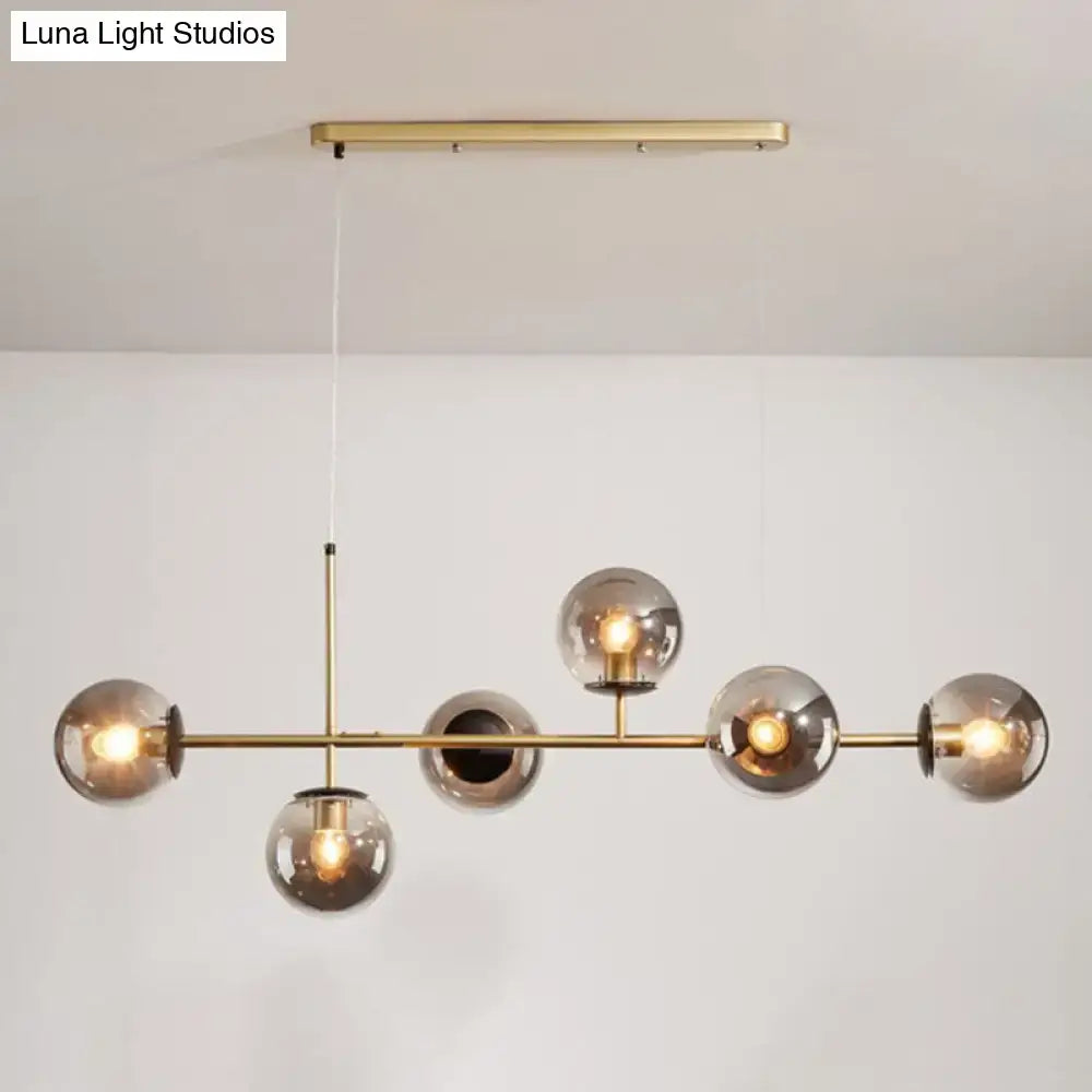 Modern black and white bird linear island pendant light with brass frame and five smoked glass shades for dining room