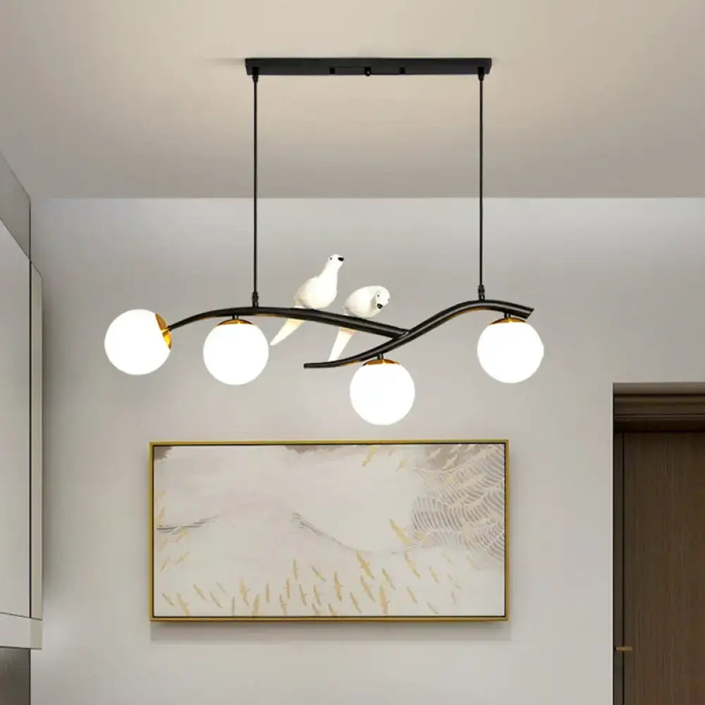 Modern black and white bird linear island pendant light with three spherical glass shades for dining room use
