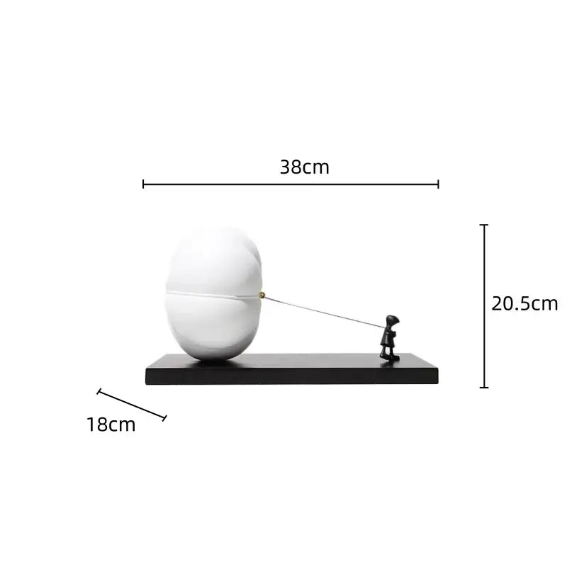 White glossy resin cartoon balloon man sculpture pulling string on oversized egg shaped object for living room decor