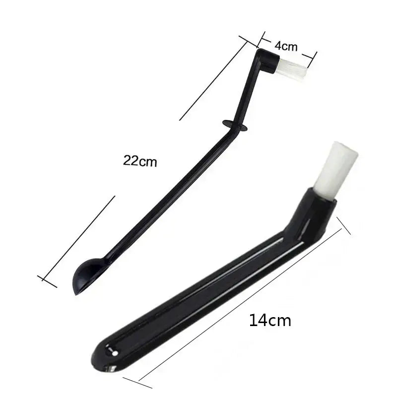 Modern black and white decorbites coffee machine brush with a black plastic scoop and white bristle brush attachment