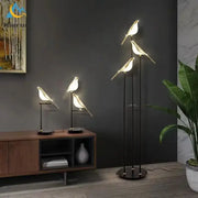 Modern black and white crow led floor lamp with sleek metal frame and glowing translucent body for living room decorbites decor