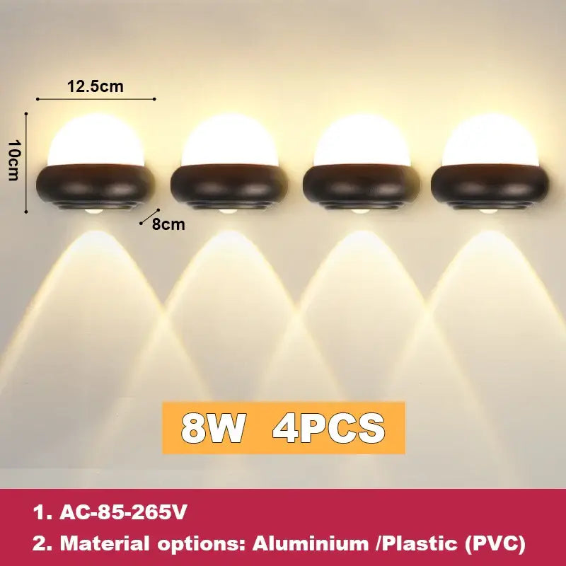 Four identical modern black and white dome led wall lamps with rounded white diffusers for bedroom and garden lighting solutions
