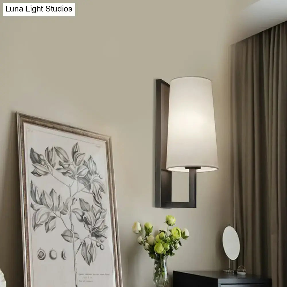 Modern black and white fabric wall lamp with matte black metal frame and off-white shade for bedroom lighting