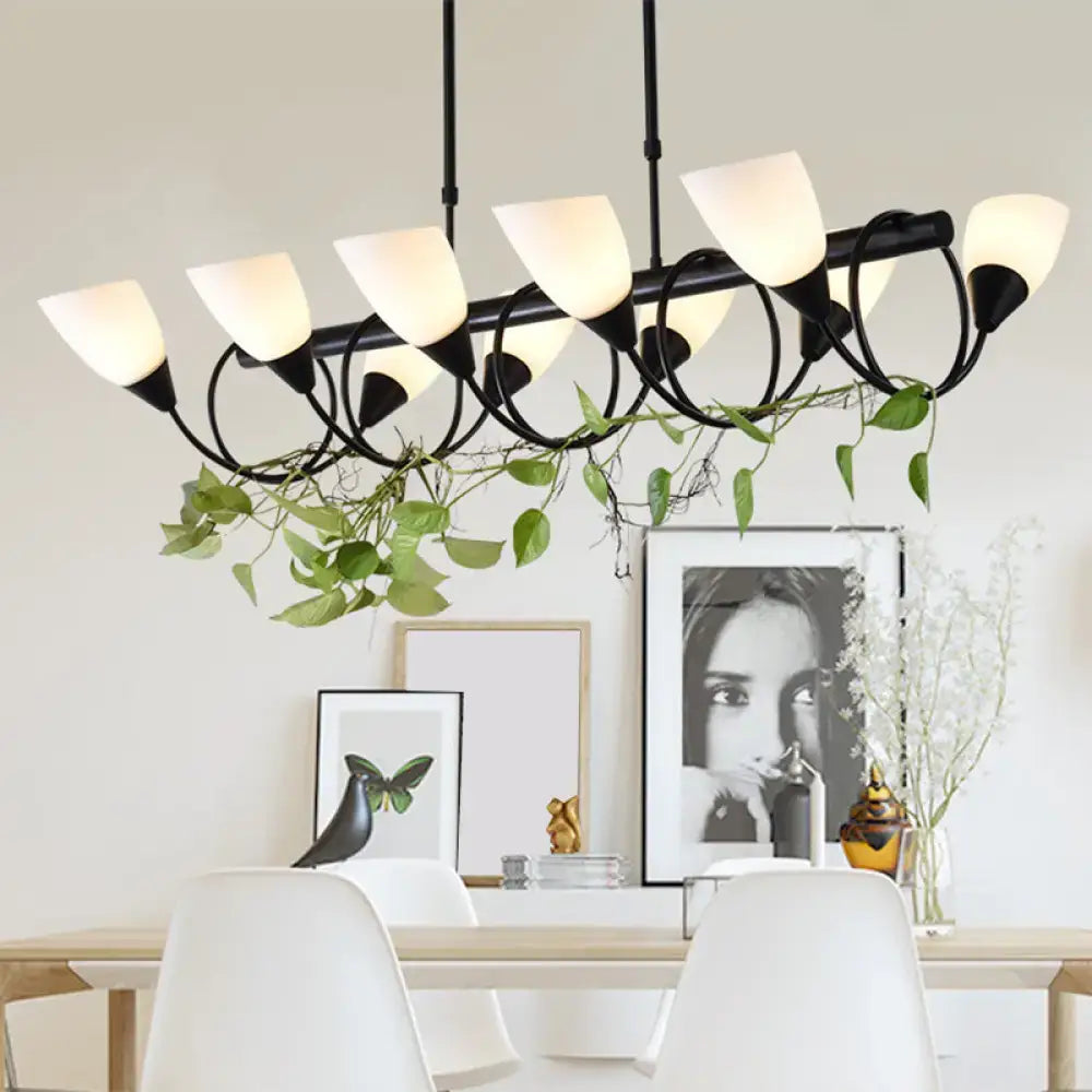 Modern black metal kitchen pendant light fixture with frosted glass shades and hanging green vines for kitchen pendant use