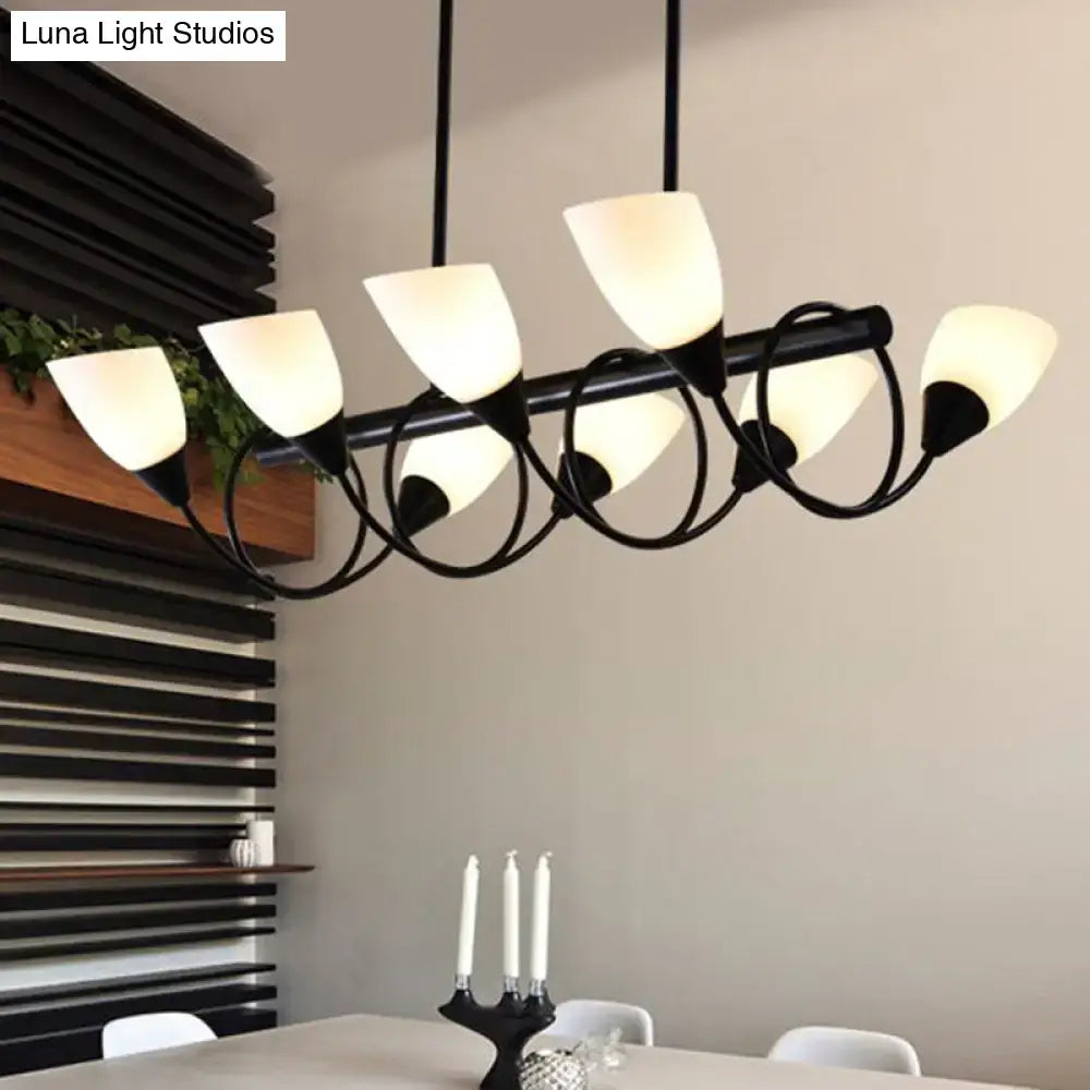Modern black metal light fixture with six frosted glass shades as a kitchen pendant light for dining areas