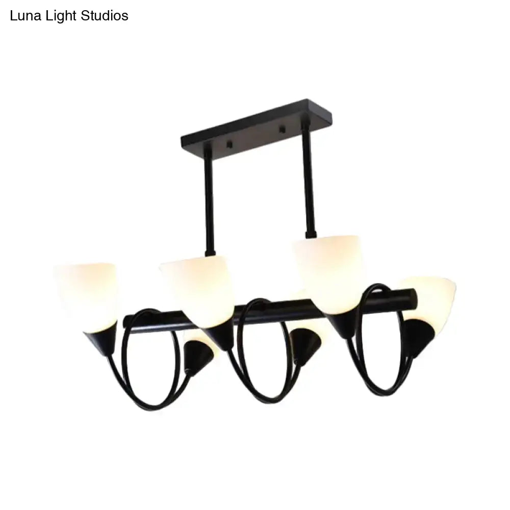 Modern black metal light fixture with five frosted glass shades for use as a kitchen pendant light