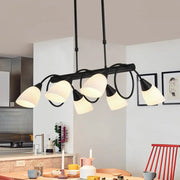 Modern black metal light fixture with six frosted glass shades designed as a kitchen pendant light